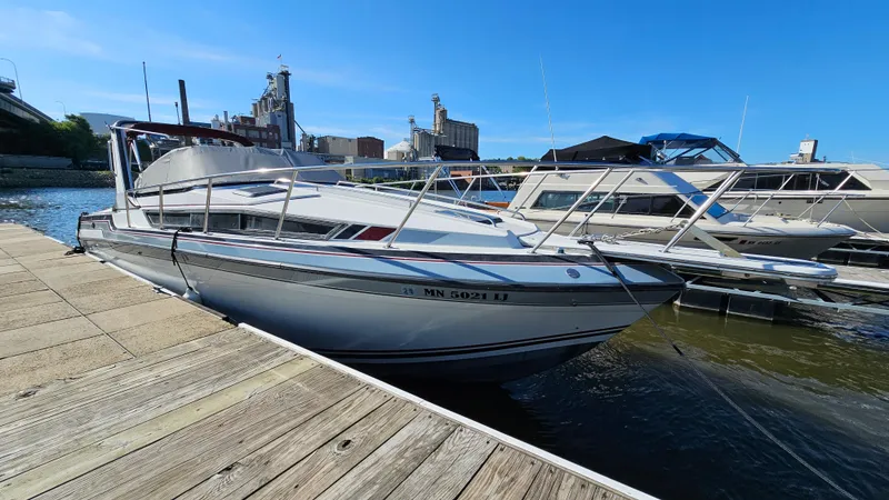 Slide: The Image of 1988 Formula 26 PC boat docked at a marina on a sunny day. - 1