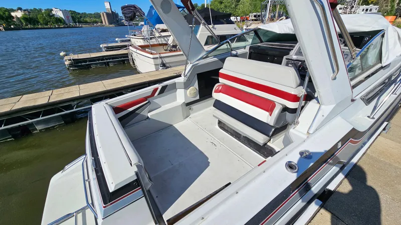 Slide: The Image of 1988 Formula 26 PC boat docked, featuring spacious seating and a clean deck. - 10