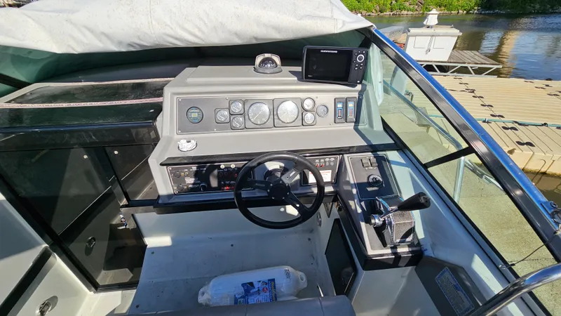 Slide: The Image of 1988 Formula 26 PC boat cockpit with steering wheel and control panel. - 11