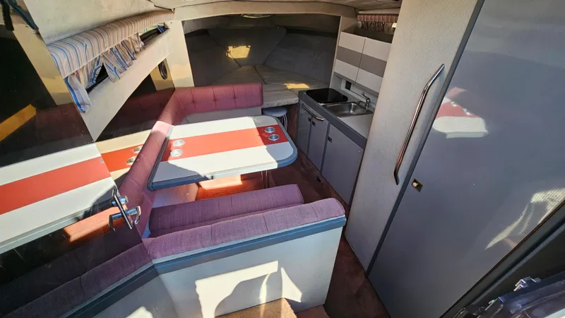 Slide: The Image of Interior of 1988 Formula 26 PC boat with dining area and kitchenette. - 14