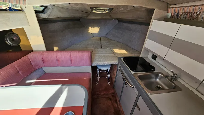 Slide: The Image of Interior of a 1988 Formula 26 PC boat with kitchen, seating, and sleeping area. - 16