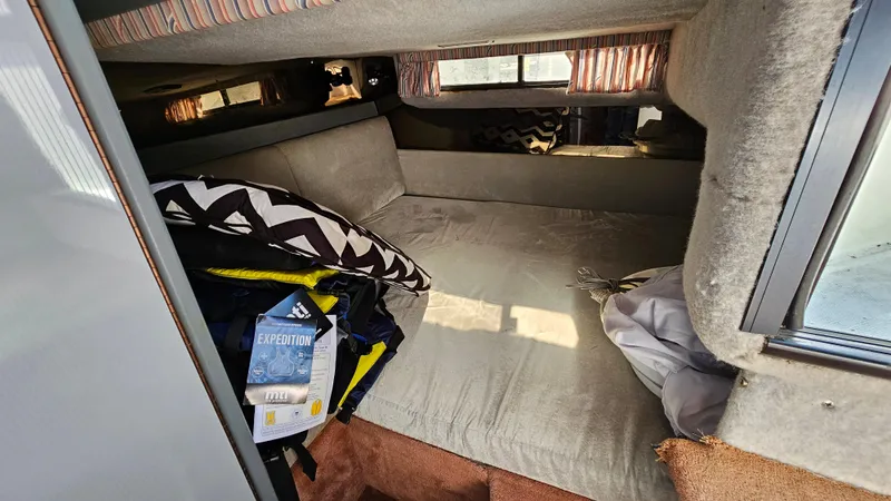 Slide: The Image of Interior cabin of a 1988 Formula 26 PC boat with bed and pillows. - 20