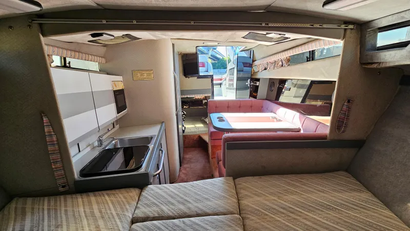 Slide: The Image of Interior of a 1988 Formula 26 PC boat with kitchen and dining area. - 22