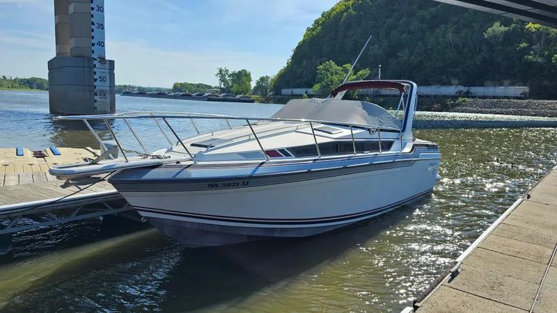 Slide: The Image of 1988 Formula 26 PC boat docked on a sunny day. - 26