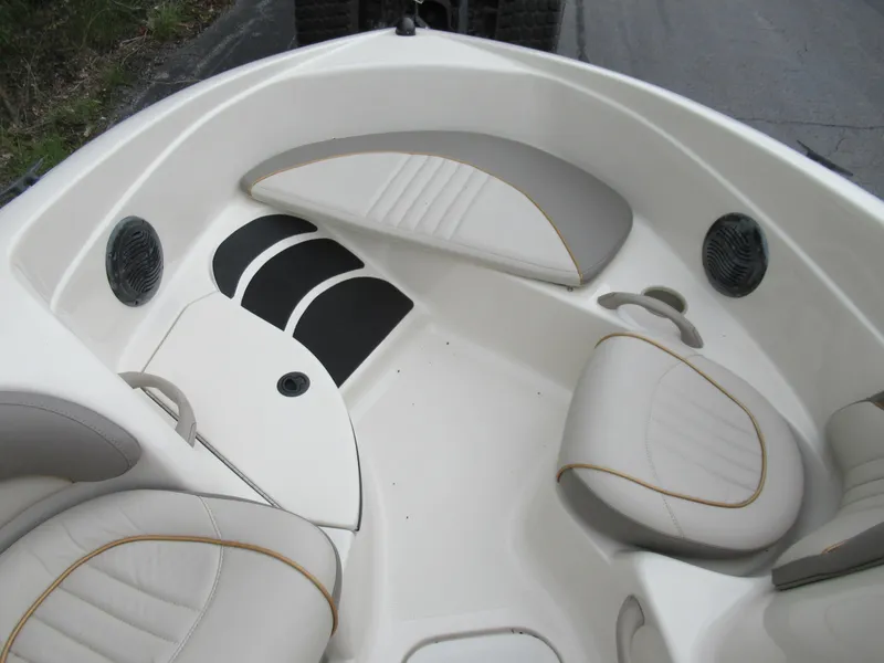 Slide: The Image of 2004 Sugar Sand Tango Xtreme boat interior with cushioned seating and speakers. - 10