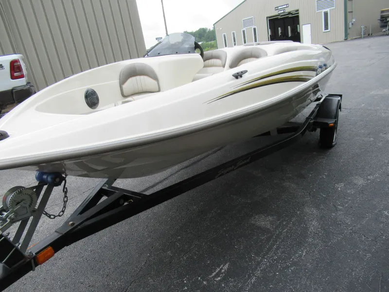 Slide: The Image of 2004 Sugar Sand Tango Xtreme boat on a trailer in a parking lot. - 7