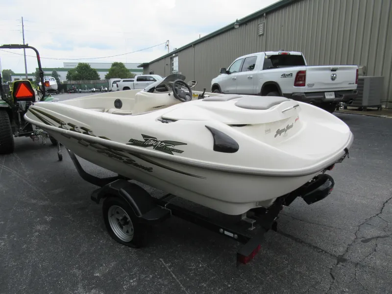 Slide: The Image of 2004 Sugar Sand Tango Xtreme boat on a trailer in a parking lot. - 8