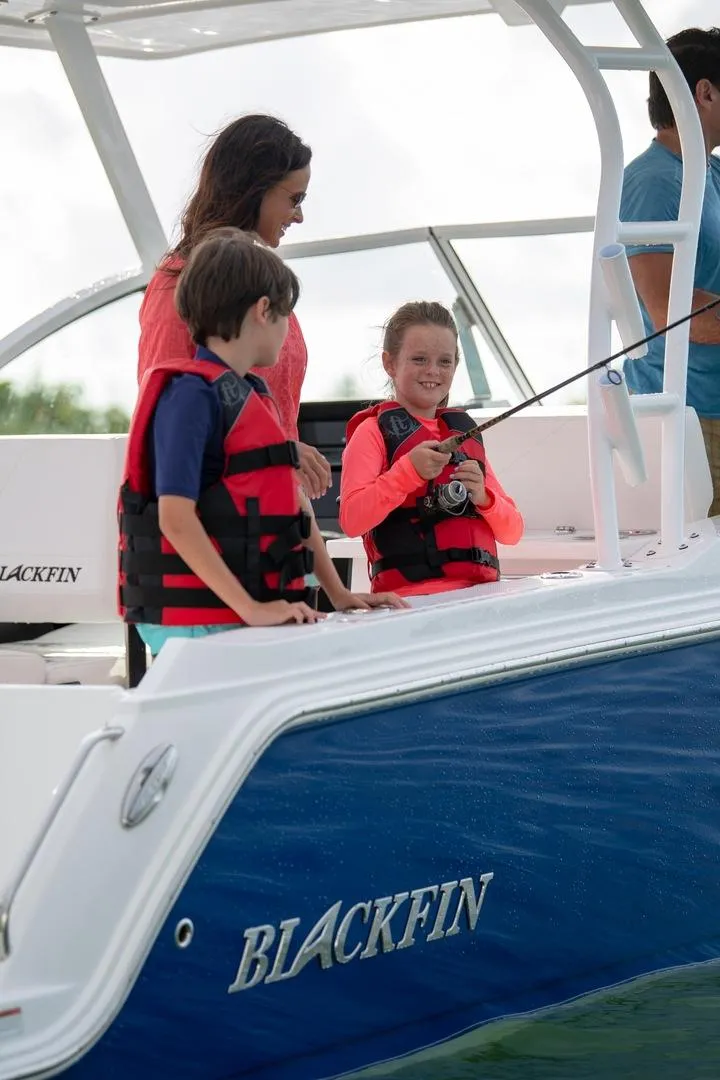 Slide: The Image of Family enjoying fishing on a 2024 Blackfin 252DC boat. - 13