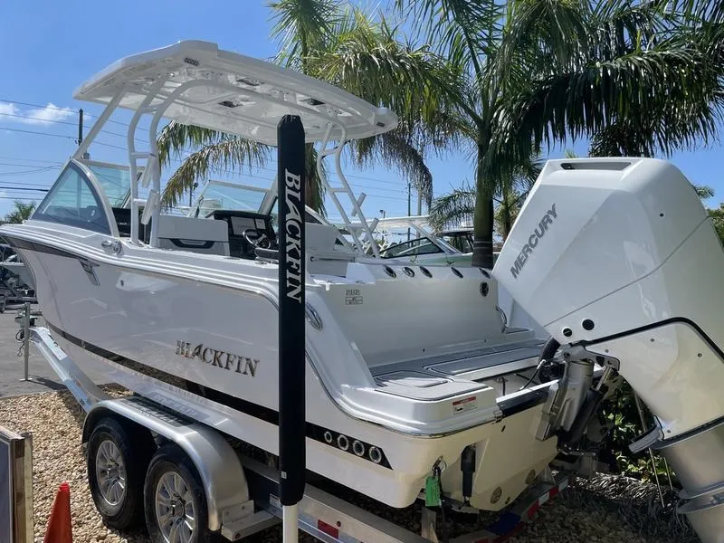 Slide: The Image of 2024 Blackfin 252DC boat on trailer with Mercury outboard motor. - 6