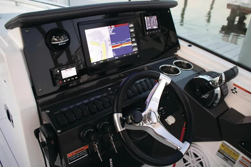 Slide: The Image of 2024 Blackfin 252DC boat dashboard with navigation display and steering wheel. - 9