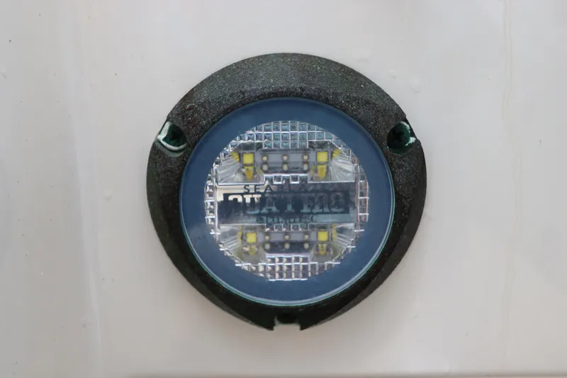 Slide: The Image of Close-up of a 2021 Robalo 246 Cayman SD boat's underwater LED light. - 11