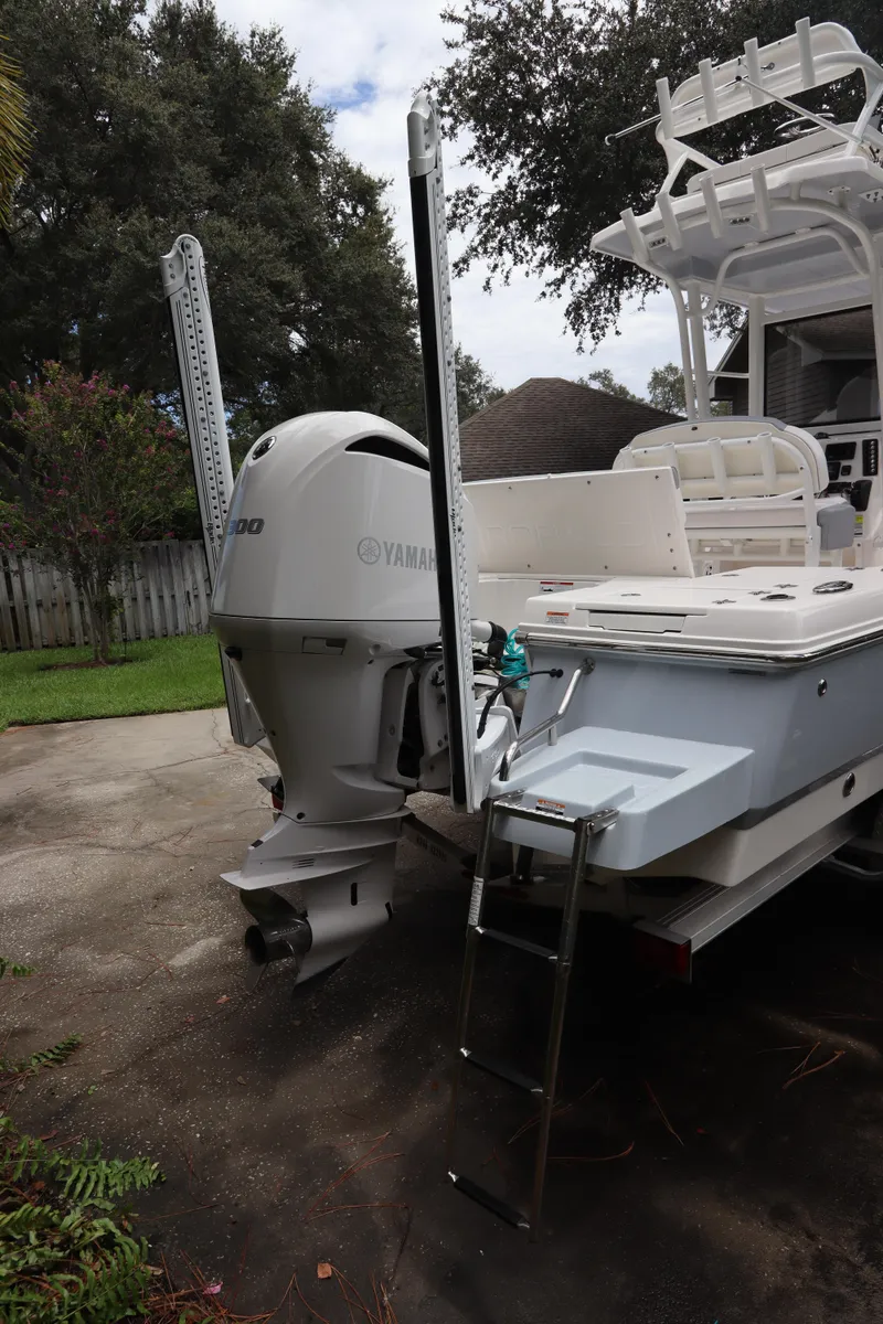 Slide: The Image of 2021 Robalo 246 Cayman SD boat with Yamaha outboard motor and swim ladder. - 12