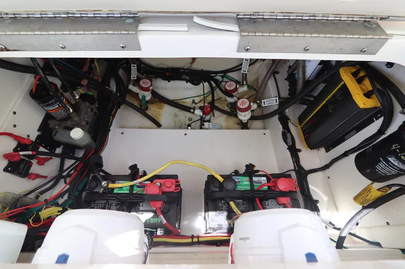 Slide: The Image of 2021 Robalo 246 Cayman SD boat battery compartment with wiring and components. - 14