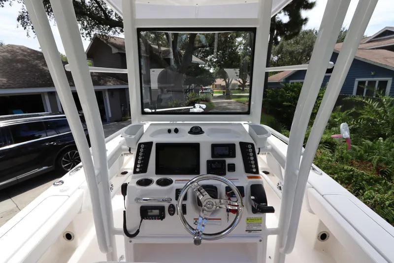 Slide: The Image of 2021 Robalo 246 Cayman SD boat console with steering wheel and navigation equipment. - 23