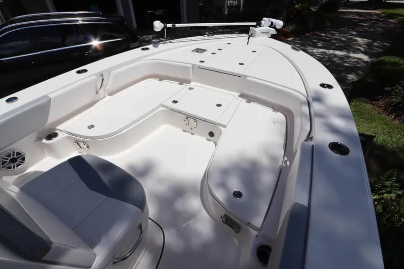 Slide: The Image of 2021 Robalo 246 Cayman SD boat interior with seating and storage compartments. - 31