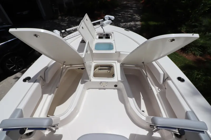 Slide: The Image of 2021 Robalo 246 Cayman SD boat with open storage compartments. - 32