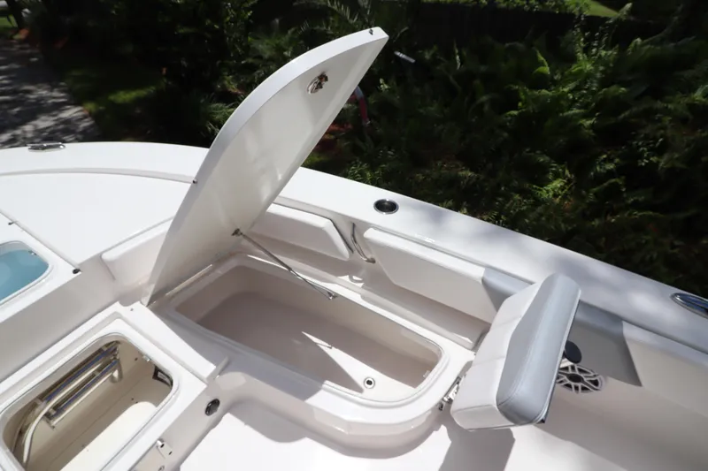 Slide: The Image of 2021 Robalo 246 Cayman SD boat storage compartment and seating area. - 34