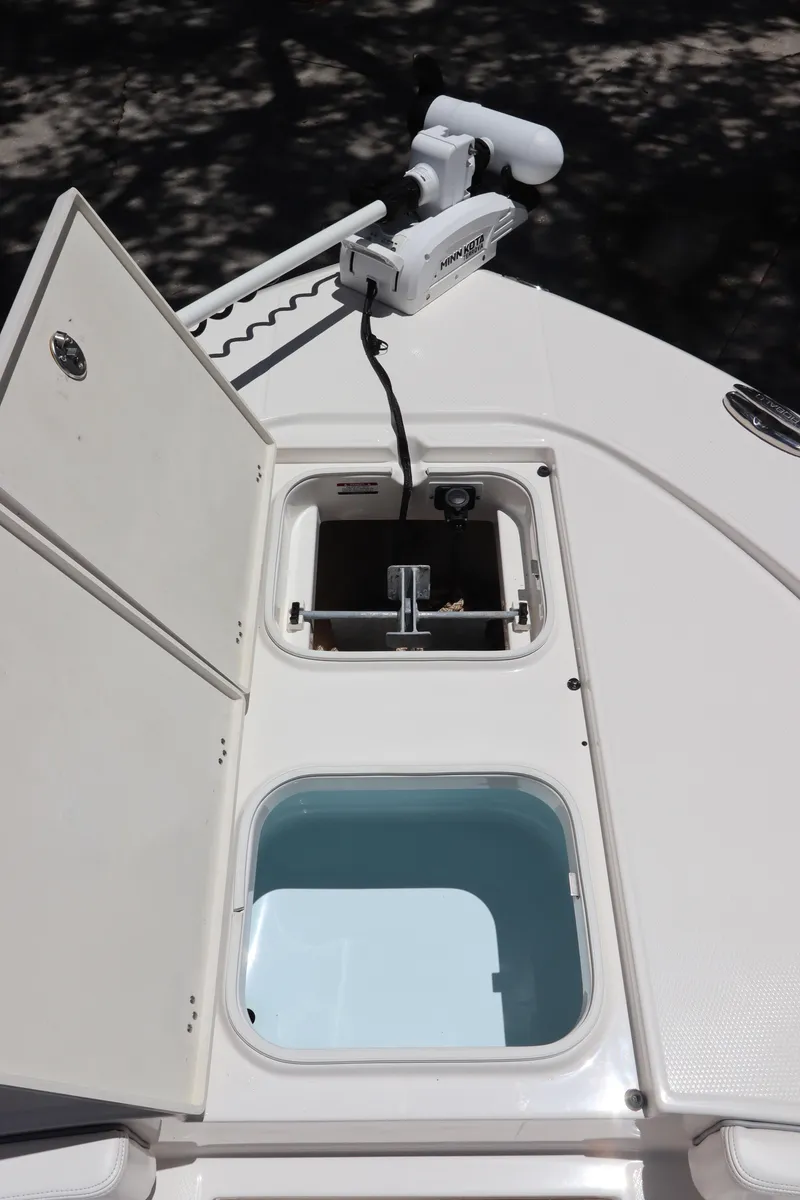 Slide: The Image of 2021 Robalo 246 Cayman SD bow storage compartments and trolling motor. - 36