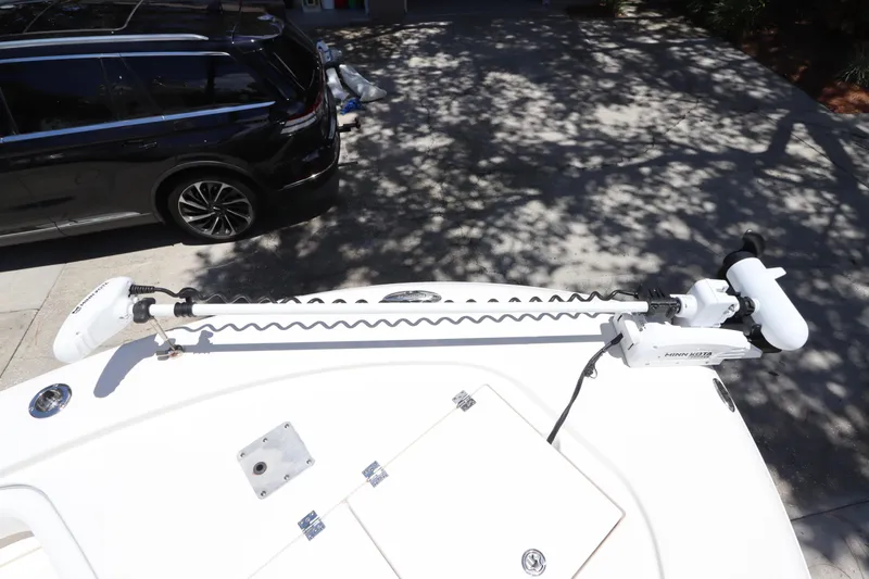 Slide: The Image of 2021 Robalo 246 Cayman SD boat with trolling motor in driveway. - 37