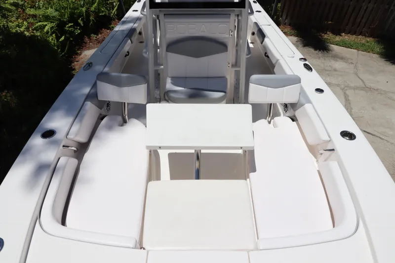 Slide: The Image of 2021 Robalo 246 Cayman SD boat interior with white seating and table. - 40
