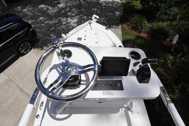 Slide: The Image of 2021 Robalo 246 Cayman SD boat helm with steering wheel and control panel. - 47