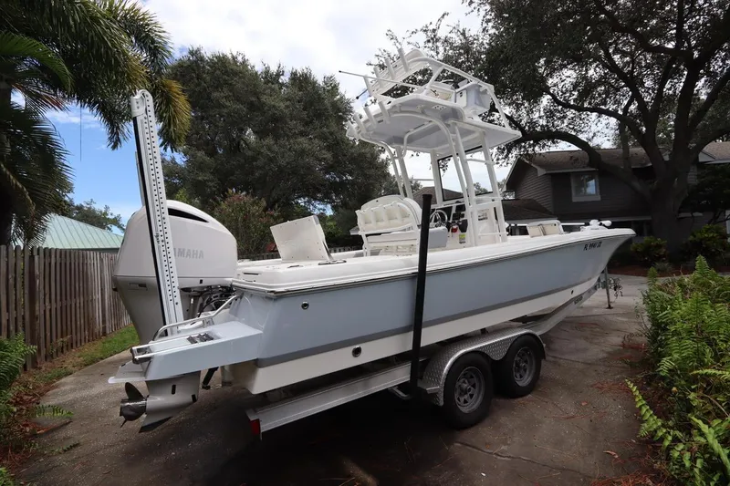 Slide: The Image of 2021 Robalo 246 Cayman SD boat on trailer in driveway. - 5