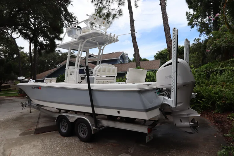 Slide: The Image of 2021 Robalo 246 Cayman SD boat on a trailer in a driveway. - 6