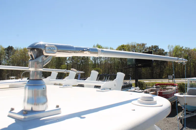 Slide: The Image of 2021 Albemarle 30 Express boat with a polished metal outrigger against a clear sky. - 11