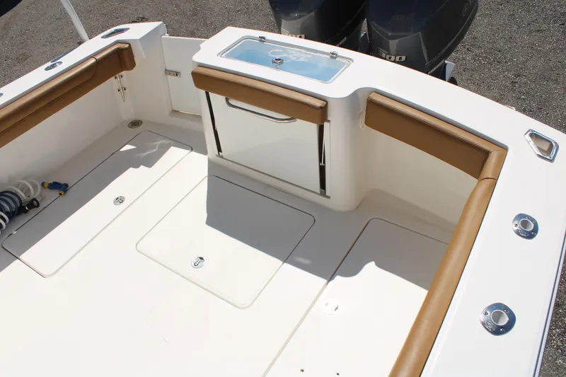 Slide: The Image of 2021 Albemarle 30 Express boat deck with cushioned seating and storage compartments. - 12