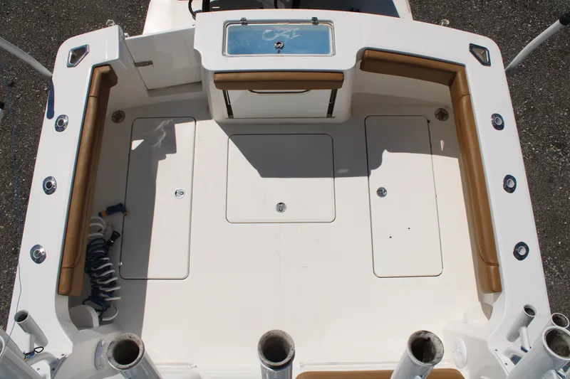 Slide: The Image of 2021 Albemarle 30 Express boat deck with cushioned seating and storage compartments. - 13