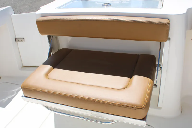 Slide: The Image of 2021 Albemarle 30 Express boat with tan cushioned seating and storage compartment. - 16