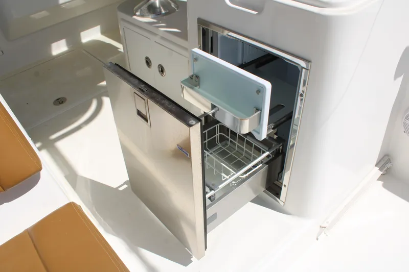 Slide: The Image of 2021 Albemarle 30 Express boat with open stainless steel refrigerator drawer. - 20