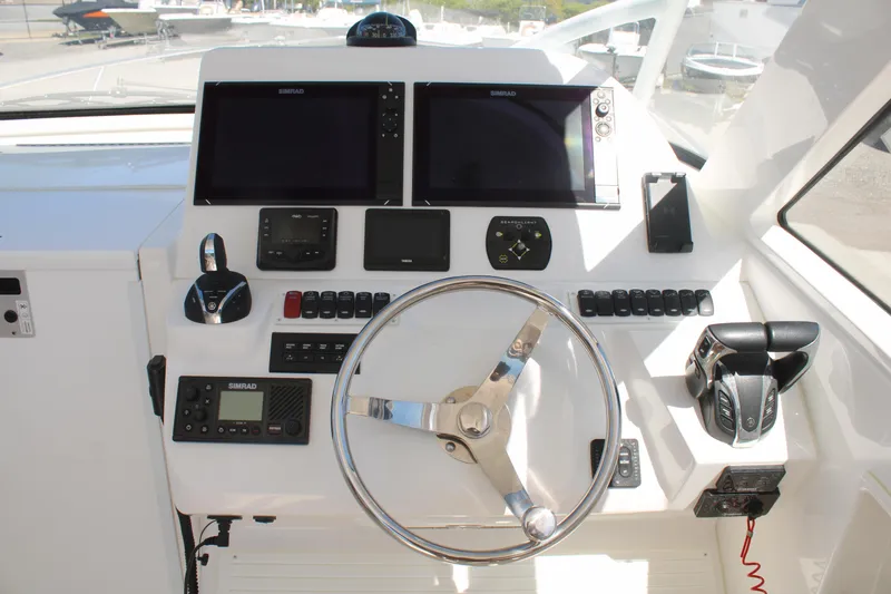 Slide: The Image of 2021 Albemarle 30 Express helm with dual displays and modern controls. - 21