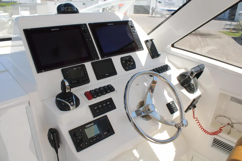 Slide: The Image of 2021 Albemarle 30 Express helm with dual displays and modern controls. - 22