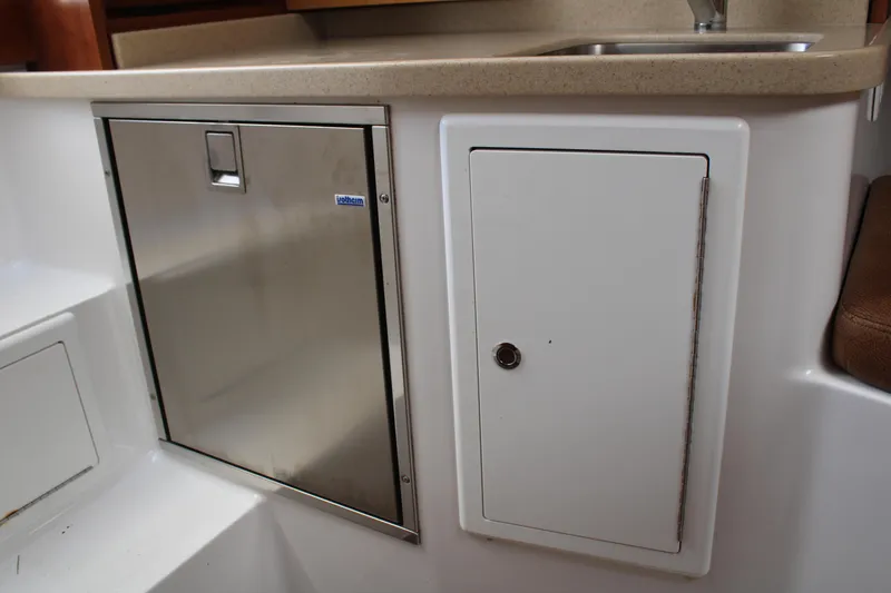 Slide: The Image of 2021 Albemarle 30 Express interior with stainless steel fridge and storage cabinet. - 33