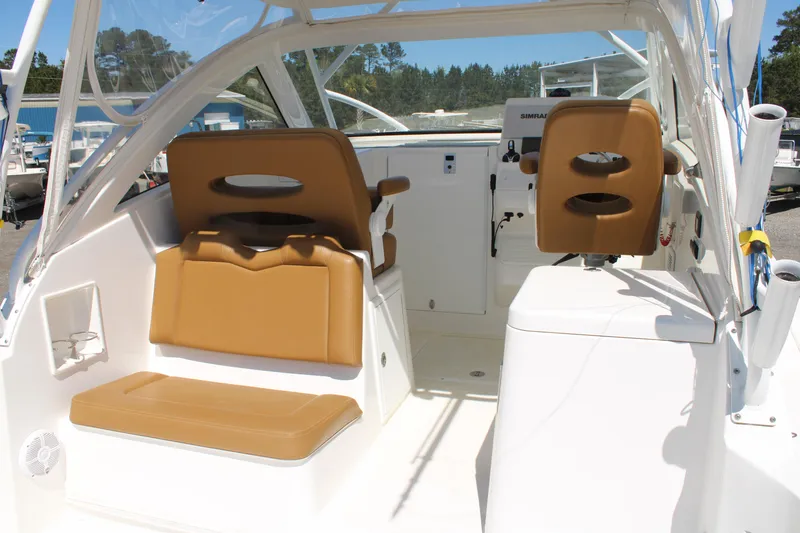 Slide: The Image of 2021 Albemarle 30 Express boat interior with tan seating and helm station. - 36