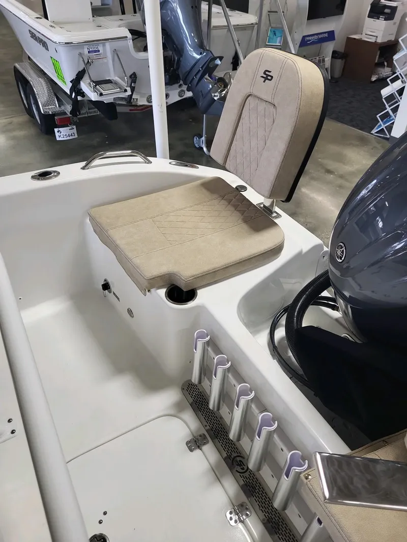 Slide: The Image of 2024 Sea Pro 199 Center Console boat interior with seating and rod holders. - 6