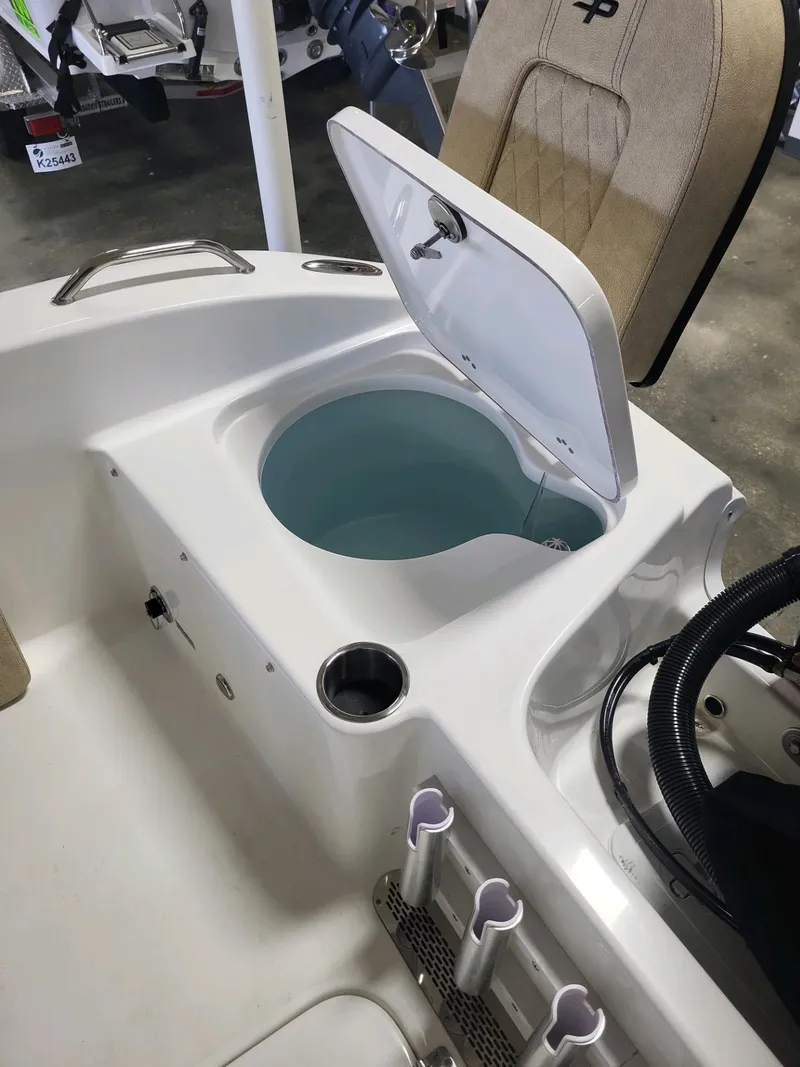 Slide: The Image of 2024 Sea Pro 199 Center Console with open livewell and rod holders. - 8