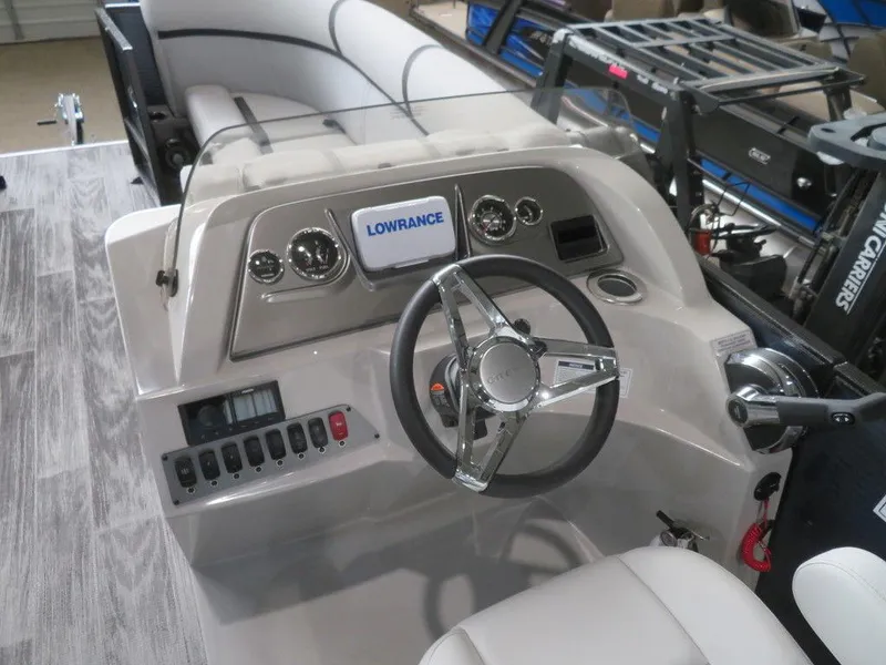 Slide: The Image of 2024 Crest Classic LX 220 SLRC boat dashboard with steering wheel and Lowrance display. - 12