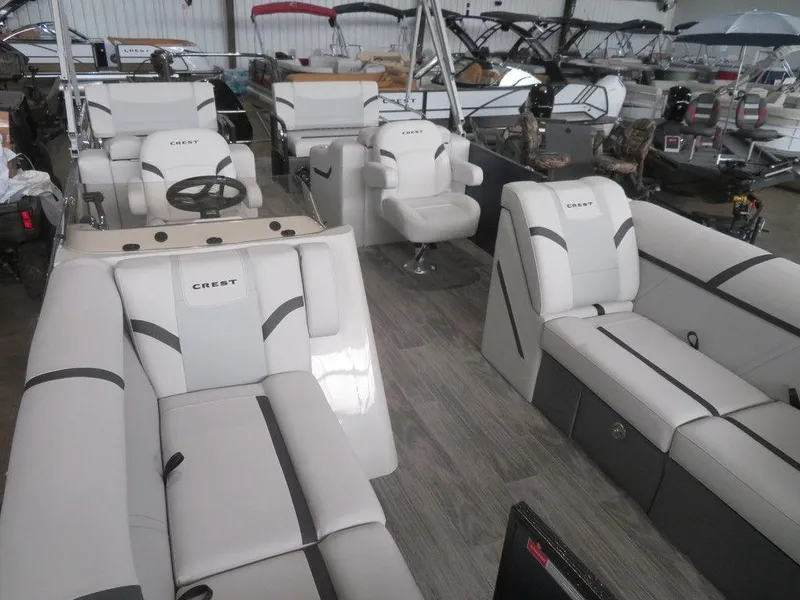 Slide: The Image of 2024 Crest Classic LX 220 SLRC pontoon boat interior with white and gray seating. - 13