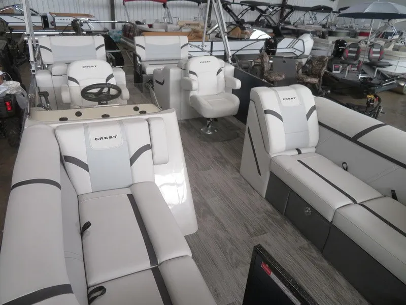 Slide: The Image of 2024 Crest Classic LX 220 SLRC pontoon boat interior with luxurious seating. - 14
