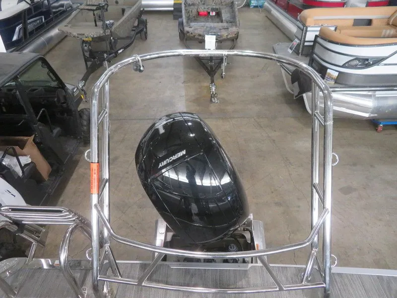 Slide: The Image of 2024 Crest Classic LX 220 SLRC pontoon boat with Mercury outboard motor in showroom. - 3