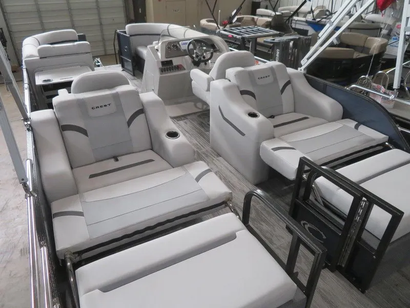 Slide: The Image of 2024 Crest Classic LX 220 SLRC pontoon boat with luxurious seating and modern design. - 5