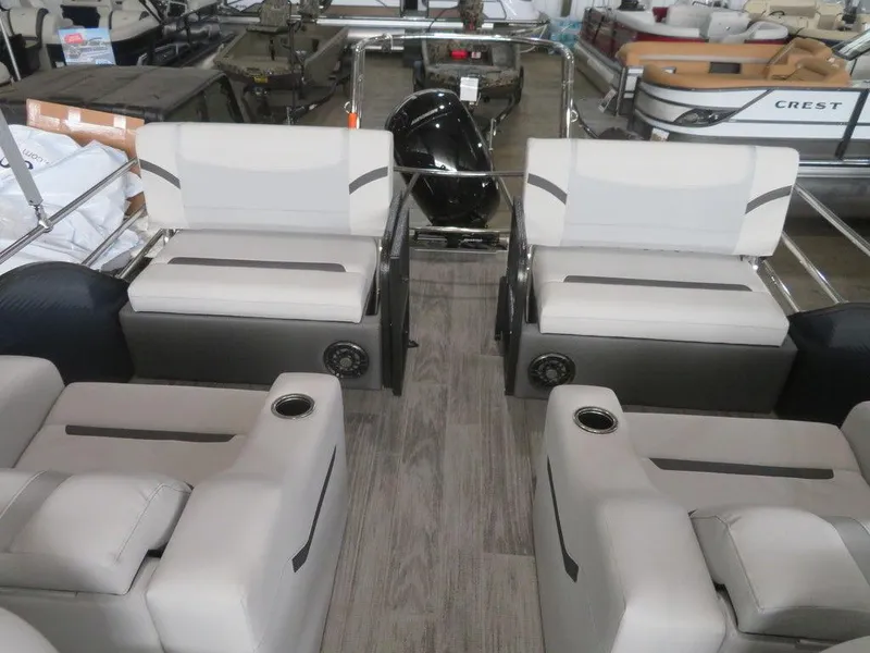 Slide: The Image of 2024 Crest Classic LX 220 SLRC pontoon boat interior with plush seating and modern design. - 6