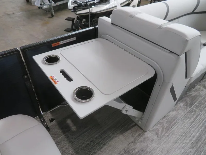 Slide: The Image of 2024 Crest Classic LX 220 SLRC boat with fold-out table and cup holders. - 8