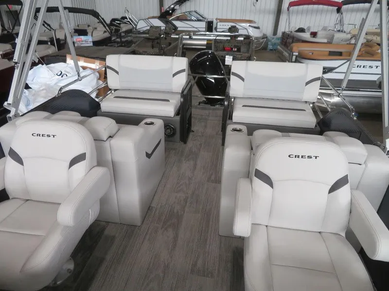 Slide: The Image of 2024 Crest Classic LX 220 SLRC pontoon boat interior with luxurious seating. - 9