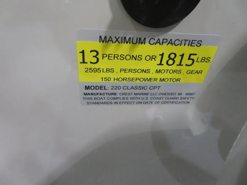 Slide: The Image of 2024 Crest Classic DLX 220 SLSC boat capacity label: 13 persons or 1815 lbs, 150 HP motor. - 10