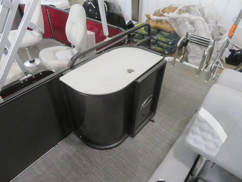 Slide: The Image of 2024 Crest Classic DLX 220 SLSC interior with seating and storage unit. - 11