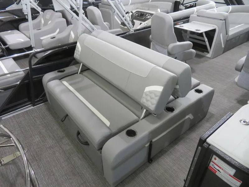 Slide: The Image of 2024 Crest Classic DLX 220 SLSC boat interior with gray seating and cup holders. - 13