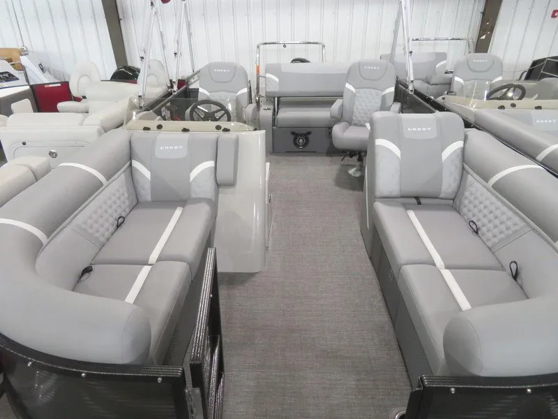 Slide: The Image of 2024 Crest Classic DLX 220 SLSC pontoon boat with spacious gray seating and modern interior. - 15